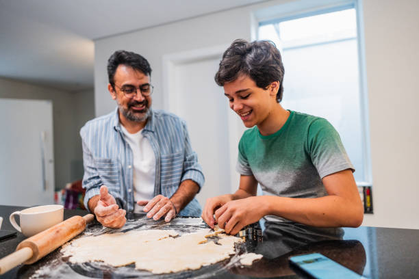istock Father and son cooking together at home 2040403706