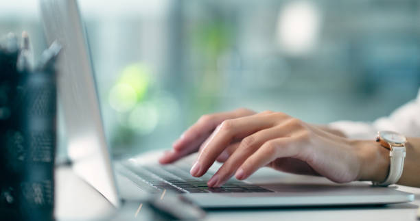 istock Laptop, hands typing and closeup at desk on email, research information and internet on pc. Computer, table and person writing on keyboard, communication and business tech of copywriter in office 2040410223