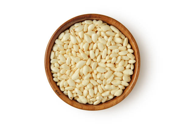 istock Puffed rice in wooden bowl on white background 2040410762
