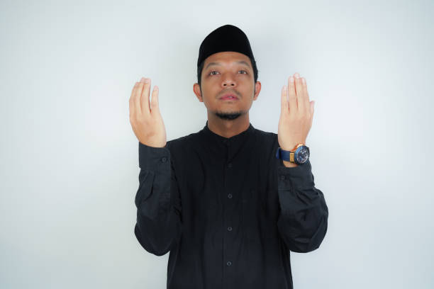 istock Asian muslim man is praying with hands up, copy space on isolated background 2040414077