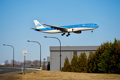 Sterling, Virginia, USA - February 25, 2024: KLM Royal Dutch Airlines A330-303 flight KL651 enroute from Amsterdam, The Netherlands, moments from touching down at Washington Dulles International Airport appears to fly over the Dulles Jet Center.