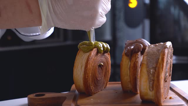 The French dessert chef adds pustachio sauce to the New York Roll dessert