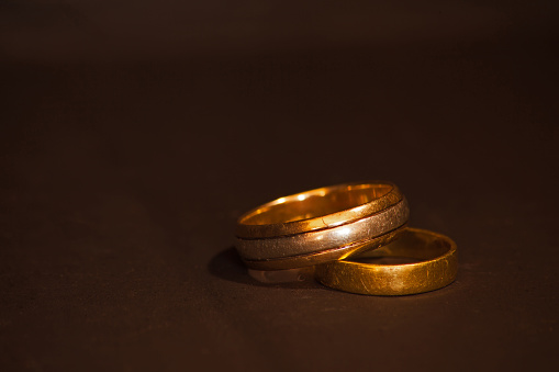 The well worn wedding bands of a couple celebrating many decades of marraige