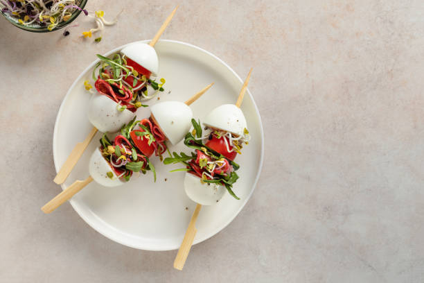 Boiled eggs salad on skewers top view on a plate