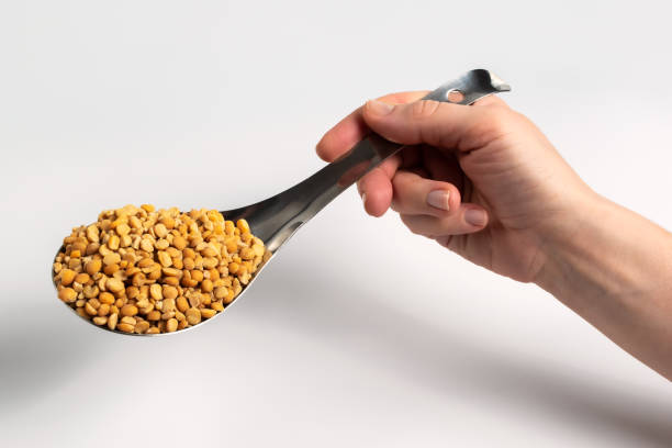 Dried chopped yellow peas on a pouring spoon stock photo