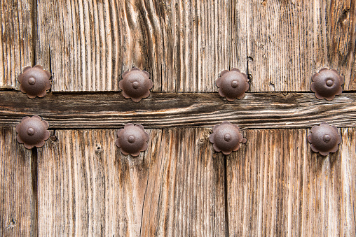 Metal and wood details of an old door in a town in Spain