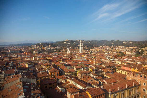 This is an elevated photograph looking out over the rooftops of the city of Verona featuring the Cathedral of Saint Maria Monticolare, (Cattedrale of Saint Maria Maticolare)