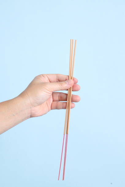 istock hand holding the incense sticks 2040492823