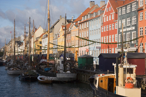 A variety of boats docked closely together in a harbor: Nyhavn Harbour, Copenhagen