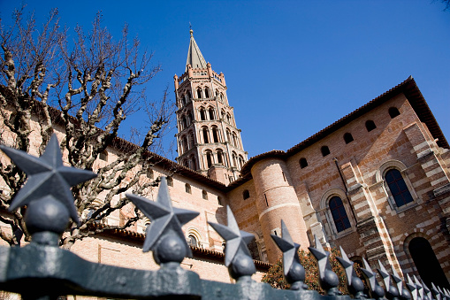 An aerial View from behind a gate of the Basilique Saint-Sernin of Toulouse