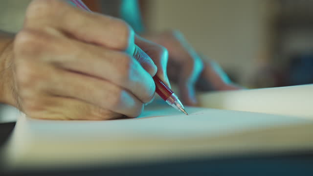 Writing on a diary with a red pen