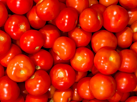 Tomato vegetables spread on a surface to be used as a background. The concept of healthy eating and delicious recipes.