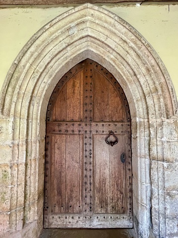 Beautiful inner front door to St Nicholas' Church dating back to the 13th and 14th centuries. Pluckley village is on the edge of the North Downs in the Ashford district of Kent. May 22, 2023.