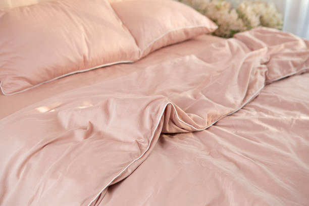 istock wrinkled light pink bed linen morning messy 2040536536