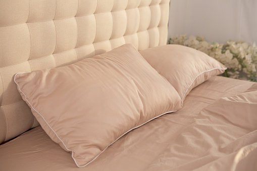crumpled beige cotton bed linen morning messy