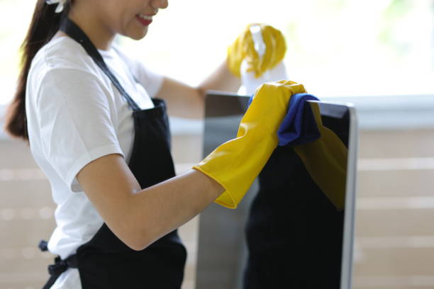 istock Young Asian cleaning woman uses a towel to clean a computer using cleaning solution in her home office. 2040543592