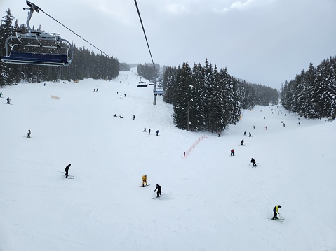 Bansko, Bulgaria – February 04, 2023: A busy ski slope filled with skiers enjoying the snowy conditions