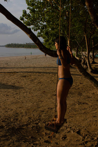 istock Woman swinging at sunset. 2040568197