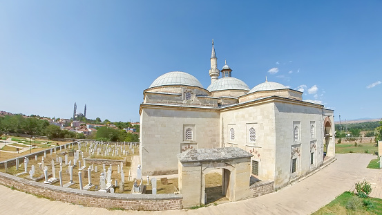 Muradiye Mosque in Edirne, Turkey. A stunning example of 15th-century Ottoman mosque. It boasts magnificent domes and a serene islamic cemetery with Selimiye Mosque on background.