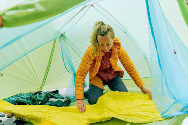 istock Woman camping inflating mattress 2040586865