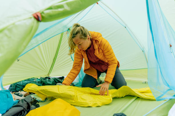 istock Woman camping inflating mattress 2040586872