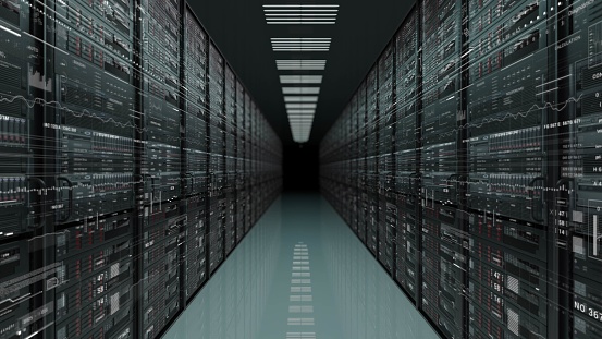 A symmetrical and dark hallway lined with rectangular metal servers, creating a pattern in a monochrome data center