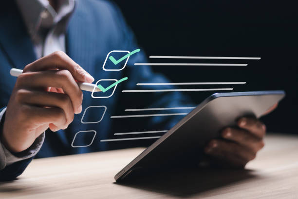 istock Business project approval concept. Businessman use tablet with making correct sign mark on checkboxes to approve corporate project. 2040633188