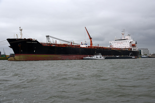 A bulk carrier at the Port of Rotterdam. Captured on a cloudy day during spring season.
