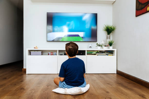 istock Boy watching television in a living room 2040642888