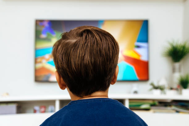 istock Boy watching television in a living room 2040642890