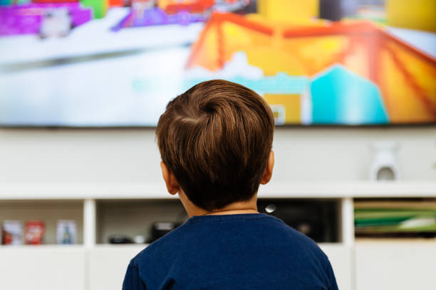 istock Boy watching television in a living room 2040642891