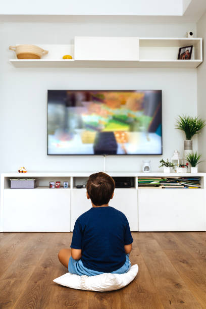 istock Boy watching television in a living room 2040642892
