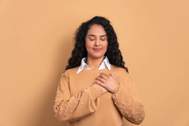 istock woman hands over heart, chest 2040645004