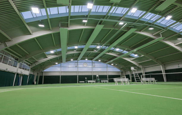Empty modern tennis hall with tennis courts. Sport and business concept.