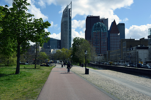 The Hague (Den Haag ) City center with several modern office buildings. The Hague is the country's administrative centre and its seat of government. The city has a population of arround 550'000 citizens. The image shows a public park and several skyscrapers, captured during spring season.