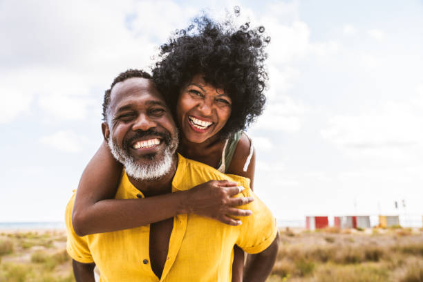 beautiful mature black couple of lovers dating at the seaside - lifestyle stock-fotos und bilder