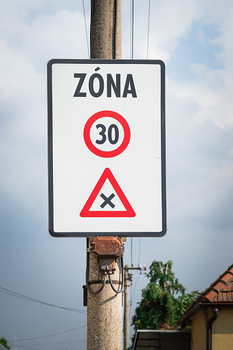 Typical 30 kmh speed limit sign used in Slovakia, Slovak traffic sign indicating a zone with reduced traffic and a speed limit of 30 kilometers per hour, crossway with priority to the right.