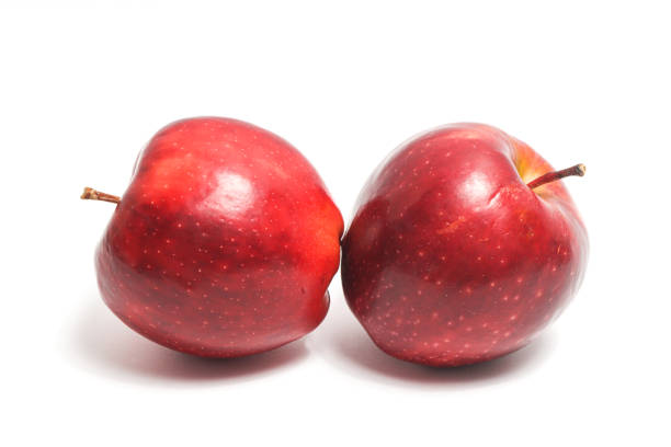 Two fresh organic red apple delicious fruit side view isolated on white background clipping path