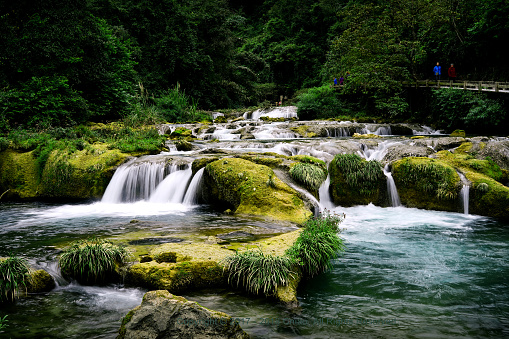 The picture was taken in Guizhou Province, China. I used slow shutter speed to capture the water flowing in the mountains, thus forming this picture.