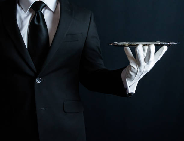 Butler Holding Serving Tray Butler in Suit and White Gloves Holding Tray silver platter stock pictures, royalty-free photos & images