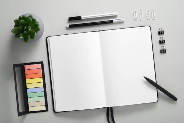istock Blank notebook page for your text with black pen and pencil on gray background. 2040679125