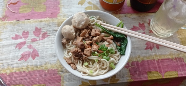 Meatball chicken noodles that are eaten with chopsticks