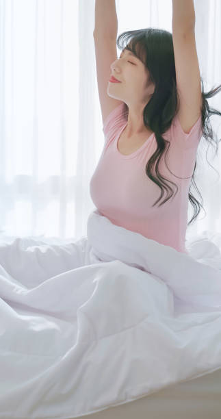 istock asian woman morning wake up 2040708712
