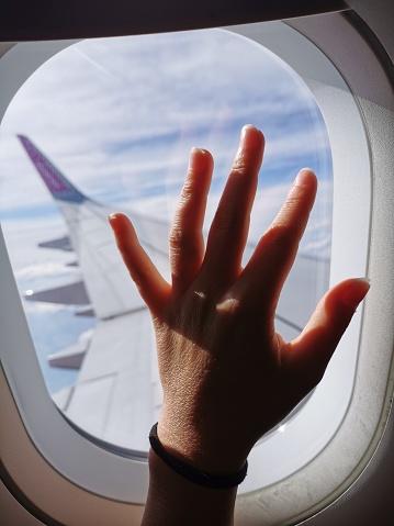 Woman's hand on the airplane window