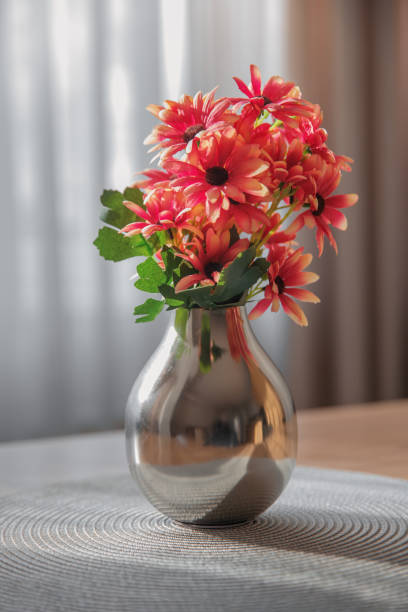 istock Silver vase with a bouquet of daisies 2040711978