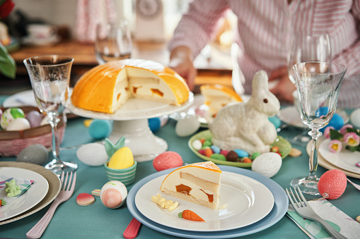 Colorful Decorated Easter Table with Easter Eggs, Flowers and Easter Cake