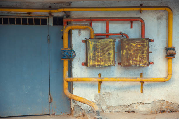 Front view of a rusty gas pipeline on the wall