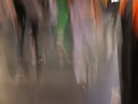 Blurred businessmen walking on footbridge