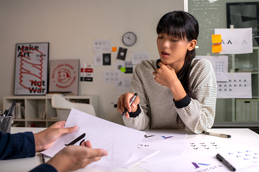 Group of Asian Graphic designer working in office. brain storming, Artist Creative Designer Illustrator Graphic Skill Concept.