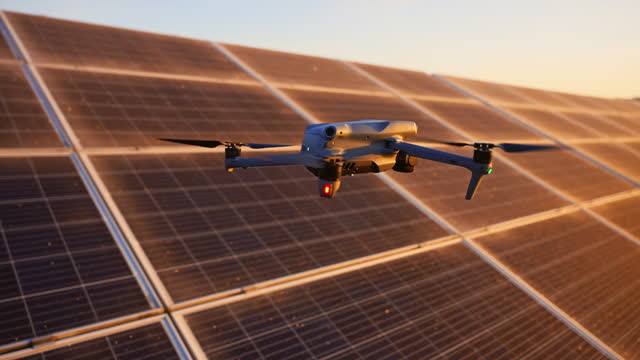 SLO MO Drone Flying Above Solar Panels Surveying at Solar Power Station at Sunset